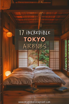 A cozy traditional Japanese room with wooden interiors, two futon beds, soft lighting, and a window view of a tranquil garden with lush greenery.