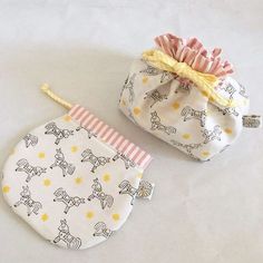 two baby bibs are sitting on a white surface