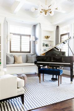 a living room filled with furniture and a grand piano