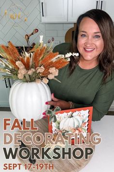 a woman sitting at a table with a card and flowers in a white pumpkin shaped vase