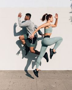 a man and woman are jumping in the air