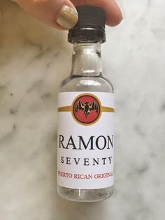 someone is holding a bottle of ramon seventy in their left hand, with the label on it