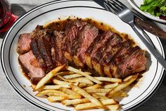 steak and french fries on a white plate