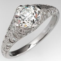 an antique style diamond engagement ring with filigrees