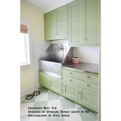 a kitchen with green cabinets and a checkered flooring pattern on the floor is shown