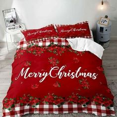 a red christmas bed set with poinsettis and checkerboard on it