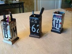 three old fashioned telephones sitting on top of a table