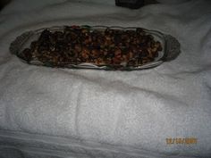 a glass dish filled with nuts on top of a white towel