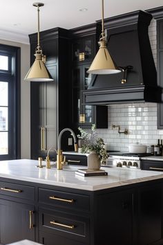 a kitchen with black cabinets and white counter tops, gold accents on the hoods