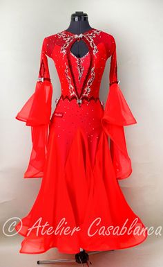 a red ballroom dress is displayed on a mannequin