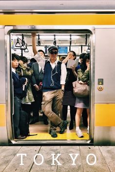 a group of people standing on a subway platform