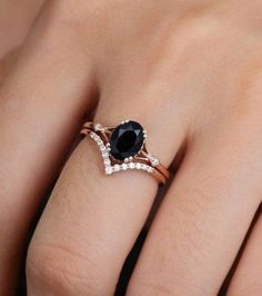 a woman's hand with a black and white diamond ring