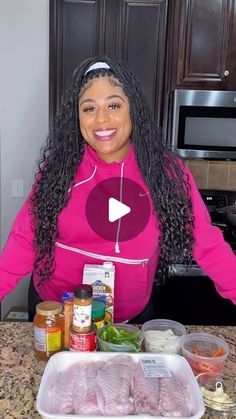 a woman standing in front of a counter filled with food and condiments on it