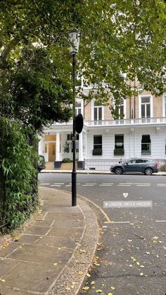 an empty street in front of a white building