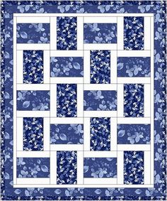 a blue and white quilt with flowers on it