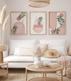 a living room filled with white furniture and paintings on the wall above it's coffee table