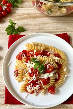 a white plate topped with pasta covered in tomato sauce and fettuccine cheese