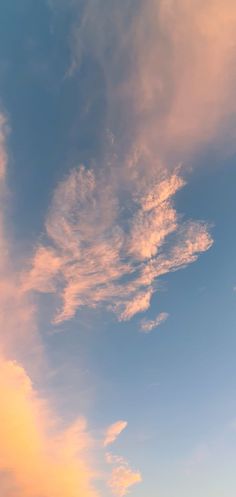 an airplane is flying in the sky at sunset or dawn with some clouds above it