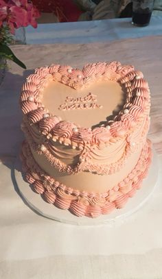 a heart shaped cake sitting on top of a table