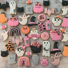 some decorated cookies are laying on a table together with halloween decorations and other items in the background