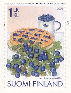 a postage stamp with blueberries and waffles on it, next to a mug