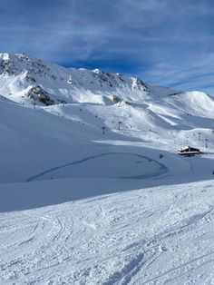 a man riding skis down the side of a snow covered slope next to a ski lift