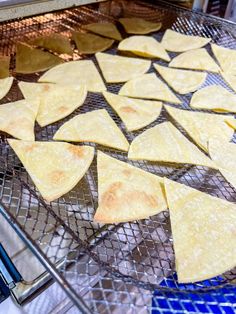 some tortilla chips are sitting on a cooling rack in the oven and ready to be cooked