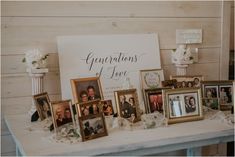 a table topped with pictures and framed photos