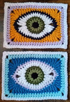 two crocheted coasters with an eye on them