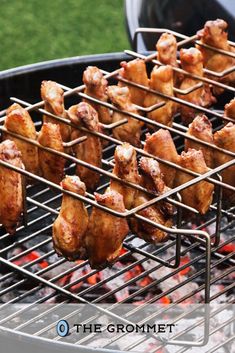 chicken wings are being cooked on the grill