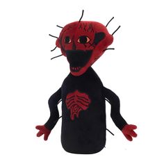 a red and black stuffed animal with spikes on it's head is standing in front of a white background