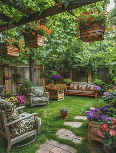 an outdoor seating area with chairs and flowers on the grass, surrounded by wooden planters