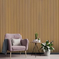 a chair, table and potted plant in front of a striped wall