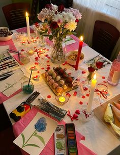 a table topped with lots of food and candles