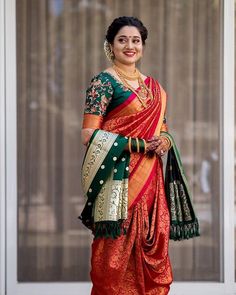 a woman in an orange and green sari