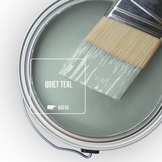 a paint can with a brush in it and the words watery on top of it