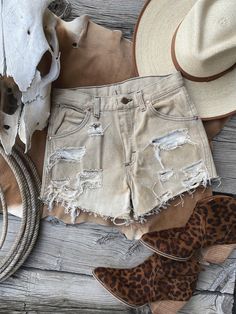 "These retro/vintage bleached wrangler jean cutoffs are so fun! Pair with your favorite boots and western graphic tee! Distressed to perfection Bleached (there is uneven staining/bleach) Retro style Tag reads youth size 14 Reg (Fit like a women's size 25 or 0) Made in Mexico 100% cotton 13MWBBK Waist laid flat 13.5\" Rise 10.5\" Hips laid flat approx. 15\" These Vintage jeans do not have stretch to them. They tend to run small. Please compare measurements provided with at-least 3 pairs of jeans Jean Cutoffs, Bleached Jeans, Western Graphic Tees, Retro Jeans, Country Girl Style, Wrangler Shirts, Jean Vintage, Favorite Boots, Cut Off Jeans