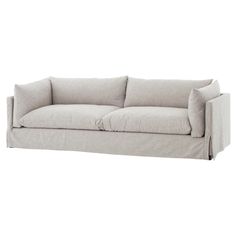 a white couch sitting on top of a wooden floor