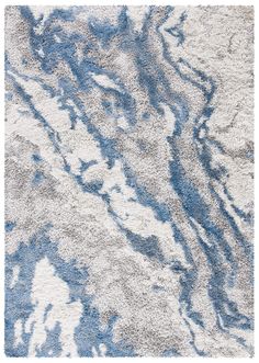 a blue and white area rug with an abstract design on the bottom half of it