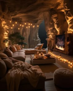 a living room filled with lots of furniture next to a stone wall covered in lights