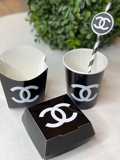 black and white paper cups with the word chanel on them