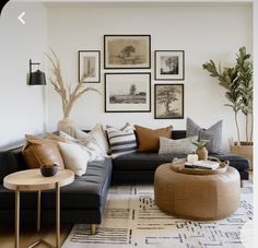 a living room filled with lots of furniture and pictures on the wall above it's coffee table