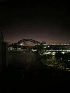 the sydney bridge is lit up at night