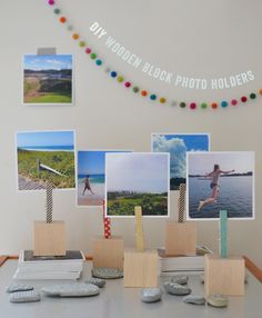 a table topped with pictures and remotes next to a string of clothes pegs