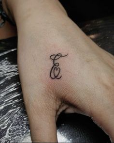 a person's foot with a small tattoo on it