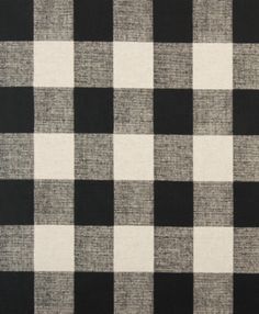 a black and white checkered fabric with a ruler in front of the plaid pattern