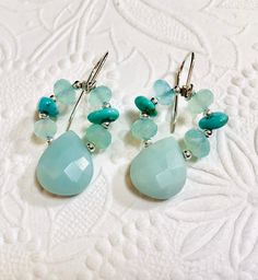 Pretty summertime earrings. Strung on beading wire, these earrings are sure to keep their shape. Made for durability. All sterling silver components. Briollet Amazonite stones measure 13 MM x 18 MM. These earrings also have Sleeping Beauty Turquoise to accent the Sea Foam Chalcedony rondells. The earrings measure just under 1 1/2" from the top of the handcrafted sterling silver ear wires. Sundance Style, Amazonite Stone, Sleeping Beauty Turquoise, Beading Wire, Seafoam Green, Green Earrings, Sea Foam, Blue Earrings, Pearl Earrings