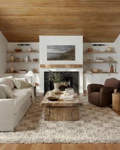 a living room filled with furniture and a fire place in the middle of a room