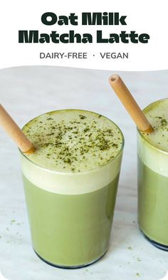 two glasses filled with green drinks sitting on top of a white table next to each other