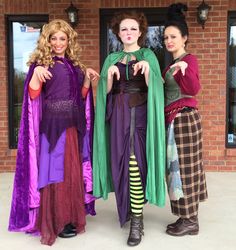 three women dressed in costumes posing for the camera